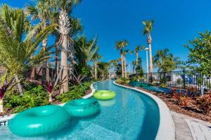 a lazy river at a resort with palm trees at Free Waterpark Private Splash Pool Near Disney in Davenport