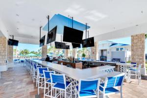 a bar with blue chairs at a restaurant at Free Waterpark Private Splash Pool Near Disney in Davenport