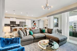 a living room with a couch and a table at NEW Magically Themed Condo w Pool View in Kissimmee