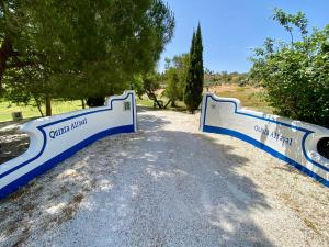 a blue and white gate on a dirt road at Quinta Alfaval in Redondo
