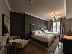 a bedroom with two beds and a desk at The Chateau Grande Hotel in East Brunswick +44 photos