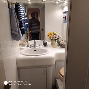 a man taking a picture of a bathroom with a sink at ΜΕΓΑΡΑ yacht Λιμανι Νέας Περάμου in Megara