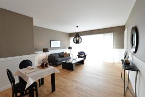 a living room with a couch and a table at Gite Urbain Henri et Joseph in Lorient