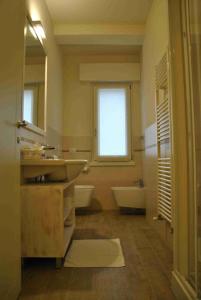 a bathroom with a sink and a tub and a window at B&B Francesca in Verona