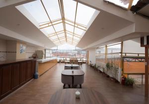 an empty lobby with a large skylight in a building at La Posada del Viajero in Cusco