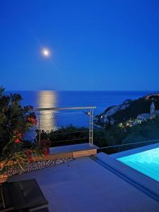 a villa with a view of the ocean at night at Bergeggi Tindari Sunrise in Bergeggi
