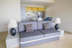 a couch in a living room with two lamps at 2063 - Lu Iba Condo 2 in Tangolunda