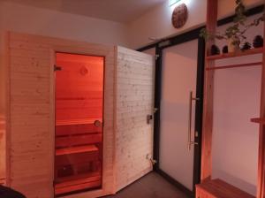 a room with a door and a brick wall at Private Relax Armonia Wellness Apartment in Svit