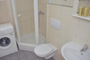 a bathroom with a toilet and a shower and a sink at SunShine in Novalja