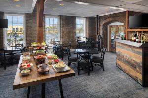 a restaurant with tables and chairs with food on them at River Street Inn in Savannah