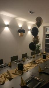 a conference room with a table with balloons on the wall at House-Cora in Stare Miasto