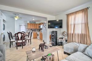 a living room and kitchen with a dog on a table at House with Pellet Smoker and Grill, 1 Mi to Lake! in Bellmawr