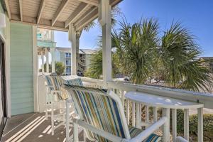 a row of chairs on a porch with a view of the beach at Emerald Isle Condo with Indoor Pool and Beach Access! in Emerald Isle