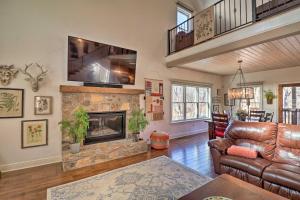 a living room with a couch and a fireplace at Riverfront Heber Springs Home Spacious Deck! in Heber Springs