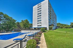 a building with a swimming pool in front of a building at Stunning Hot Springs Condo on Lake Hamilton! in Hot Springs