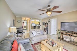 a living room with a couch and a flat screen tv at Stunning Hot Springs Condo on Lake Hamilton! in Hot Springs