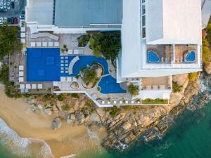 a beach scene with a large building at Fiesta Americana Acapulco Villas in Acapulco