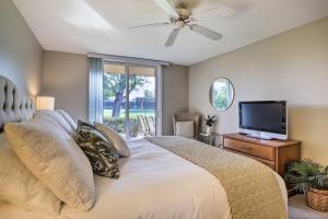 a bedroom with a large bed with a flat screen tv at Resort Amenities Rancho Mirage Country Club Home in Rancho Mirage +23 photos