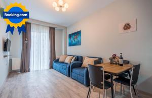 a living room with a blue couch and a table at New Gudauri, Loft 1, #114, Cosy Apartment -Gondola lift in Gudauri