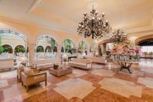 a large lobby with couches and a chandelier at Charleston Santa Teresa Cartagena in Cartagena de Indias