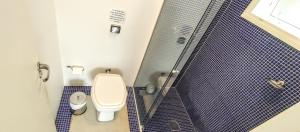 a bathroom with a toilet and a shower at Maison de L'ocean Praia 250 m in Florianópolis +37 photos