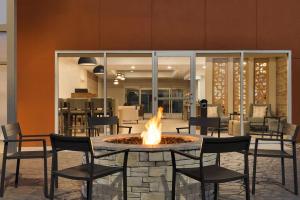 a fire pit in the middle of a room with chairs at Candlewood Suites - Lexington - Medical District, an IHG Hotel in Lexington