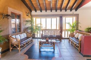 a living room with couches and a table at Casa Graciela Hotel Pátzcuaro in Pátzcuaro