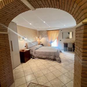 a bedroom with a bed and a brick wall at Alba Chiara in Anzio