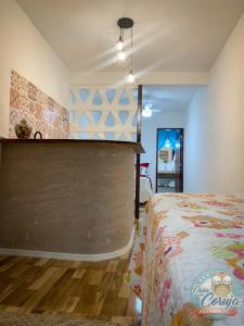 a bedroom with a bed and a wall at Casa da Coruja in Rio de Janeiro