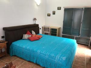 a bedroom with a blue bed with red pillows on it at Casa Enos - Ocean view Apartments Tenerife South in Granadilla de Abona