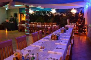 a long table in a restaurant with a christmas tree at OW JĘDRUŚ in Zawoja +33 photos