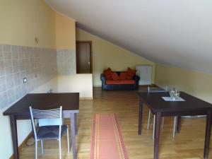 a living room with a table and chairs and a couch at Le Stanze di Bacco in Cagnano Amiterno