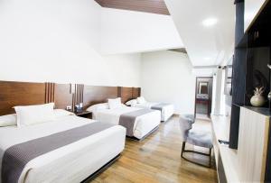 Postel nebo postele na pokoji v ubytování Hotel Sirari By Regina