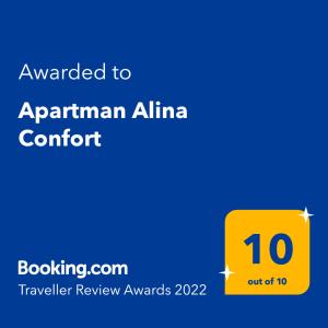 a yellow sign with the text awarded to armenian alma comfort at Apartman Alina Confort in Banja Luka