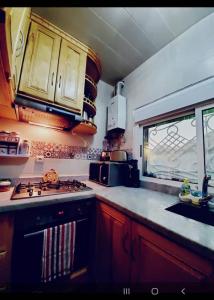 a kitchen with a stove and a sink and a window at Villa Overlooking Beach - Private Swimming Pool! in Tangier