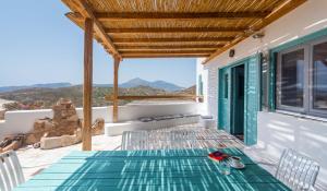 a table and chairs on a balcony with a view at Pozolani House in Péran Triovasálos +19 photos