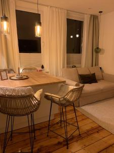 a living room with a couch and a table and chairs at Redlinburg I in Quedlinburg