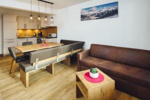 a living room with a couch and a table at Apart Simala in Serfaus