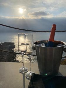 two wine glasses and a bucket with a bottle of wine at Tunquen Magico in Tunquen