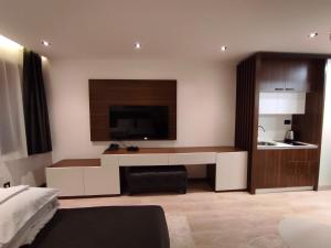 a living room with a tv on a wall at Zoned II Kopaonik - Studio Njegomir in Kopaonik