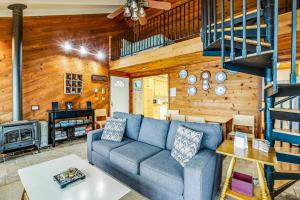 a living room with a couch and a staircase at Blue Sea Oceanfront Cottage in Oceanside