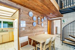 a dining room with a wooden wall with plates on it at Blue Sea Oceanfront Cottage in Oceanside