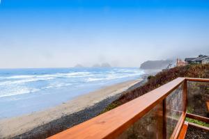 a view of the beach from the balcony of a house at Blue Sea Oceanfront Cottage in Oceanside