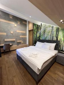 Ένα ή περισσότερα κρεβάτια σε δωμάτιο στο FORRESTO APARTMANI JAHORINA