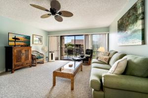 a living room with a couch and a table at Sea Village #3-203 in Kailua-Kona