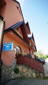 a building with a sign on the side of it at Willa Ostoja u Pyrca in Zakopane