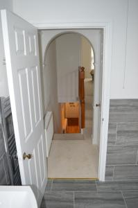 a hallway with a door leading into a room at The Crandale Road House in Bath