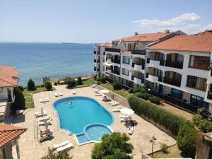 a view of a swimming pool next to some buildings at Sun Coast Apartment in Sveti Vlas