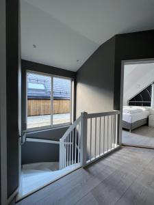 a room with a staircase with a bed and windows at Hytte på sørlandet in Kristiansand +37 photos