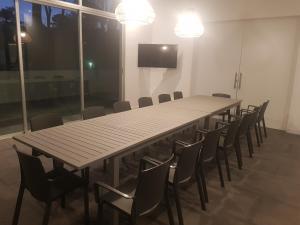 a large conference room with a long table and chairs at Ocean Drive Country - Punta del Este in Punta del Este +46 photos